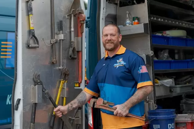 Klaus & Sons technician grabbing tools from his truck on the way to a job in Montclair, CA.