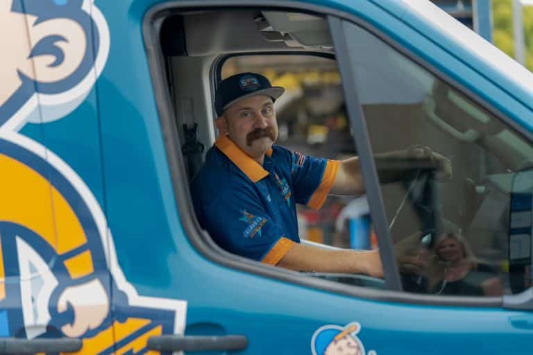 Klaus & Sons technician in a company van providing HVAC and furnace services across the Inland Empire