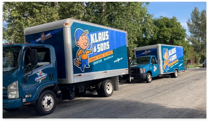 Two Branded Trucks On Street